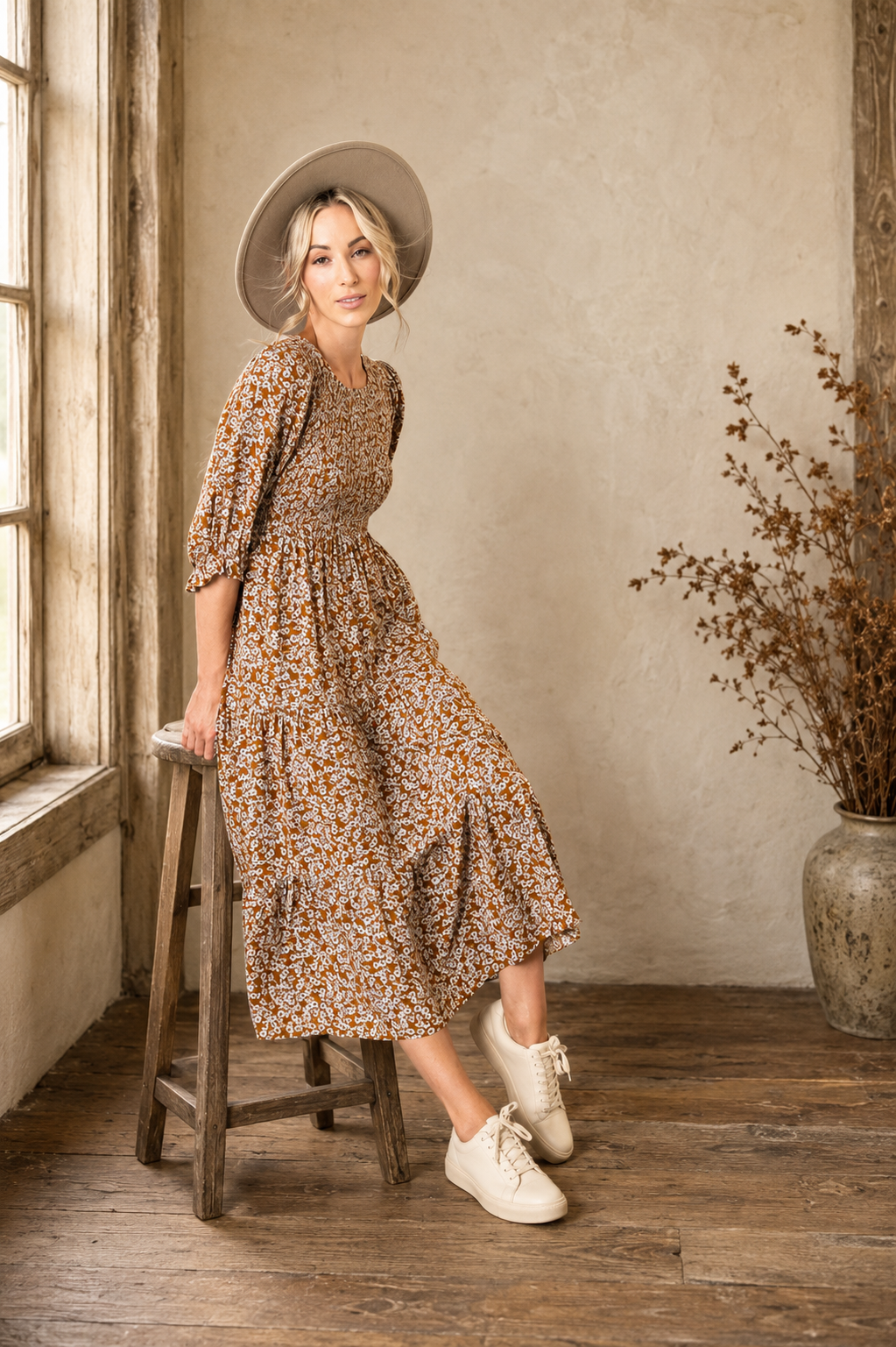 The Founder’s Dress, a copper floral midi dress with a smocked bodice, three-quarter sleeves and tiered skirt.